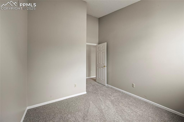 carpeted empty room with baseboards