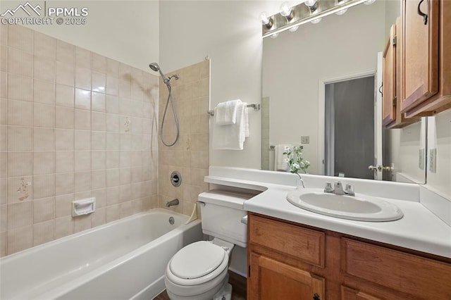 bathroom with toilet, vanity, and shower / tub combination