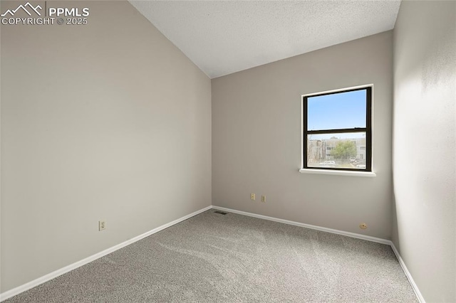 carpeted empty room featuring baseboards
