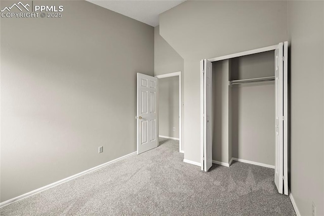 unfurnished bedroom featuring carpet flooring, baseboards, and a closet