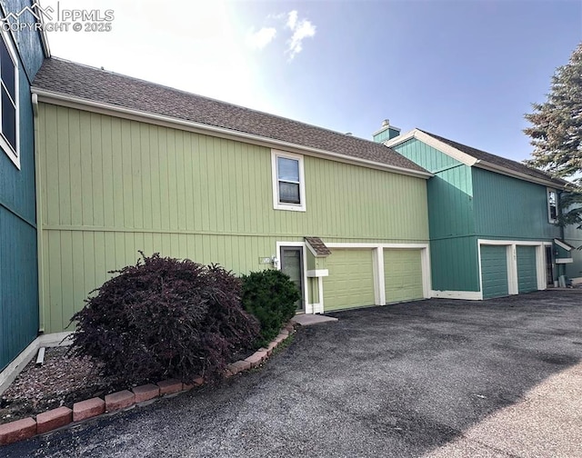 1769 Woodmoor Dr, Monument, CO 80132 - view of side of home with roof with shingles and driveway