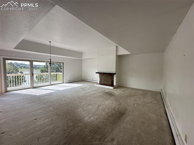 1769 Woodmoor Dr, Monument, CO 80132 - unfurnished living room with carpet floors, a textured ceiling, baseboard heating, a chandelier, and baseboards
