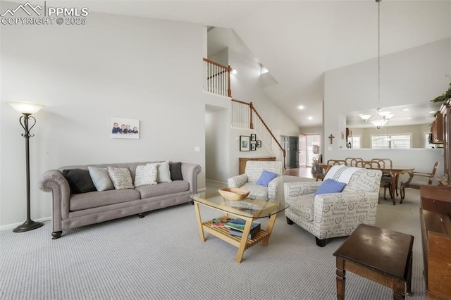 living room featuring high vaulted ceiling, carpet floors, stairs, baseboards, and a chandelier