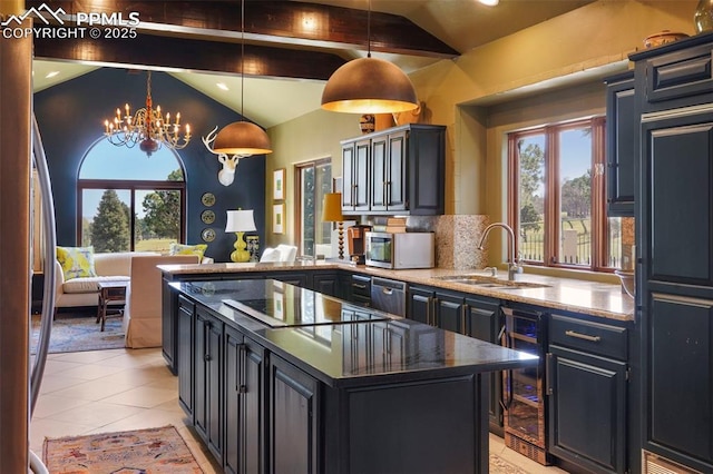3285 El Pomar Rd, Colorado Springs, CO 80906 - kitchen with a sink, stainless steel appliances, beverage cooler, a chandelier, and a kitchen island