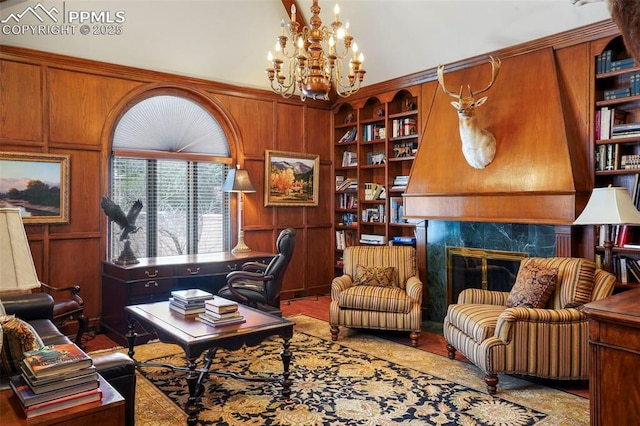 3285 El Pomar Rd, Colorado Springs, CO 80906 - office featuring a chandelier, built in shelves, a fireplace, and wood walls