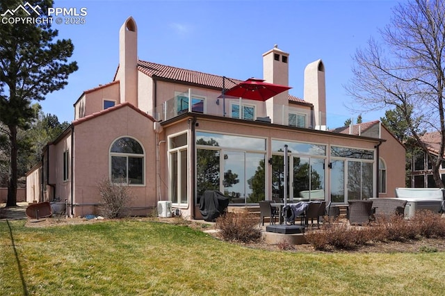 3285 El Pomar Rd, Colorado Springs, CO 80906 - back of house featuring a chimney, a tiled roof, and a yard