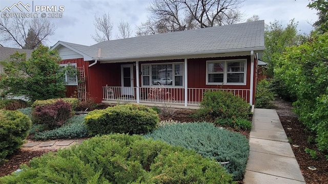 ranch-style house with covered porch and board and batten siding