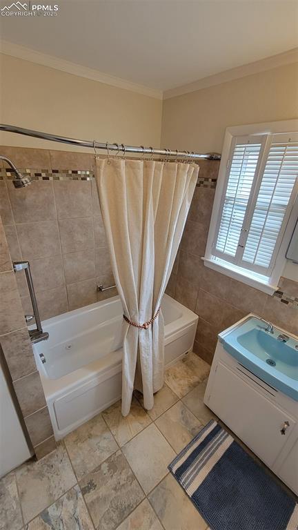 full bathroom featuring shower / tub combo, crown molding, and vanity