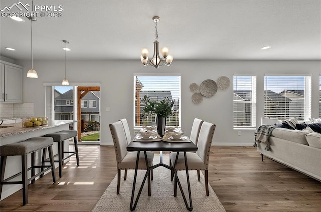 dining space featuring plenty of natural light, wood finished floors, a chandelier, recessed lighting, and baseboards