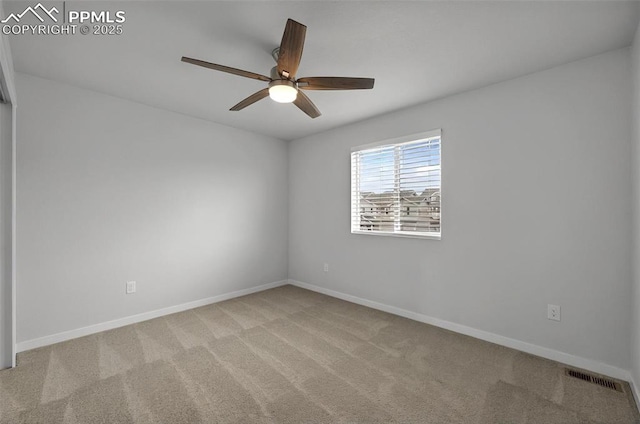 empty room with a ceiling fan, carpet floors, and baseboards