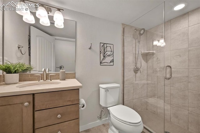 bathroom featuring toilet, a shower stall, vanity, and wood finished floors