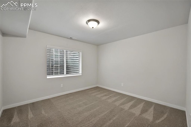 empty room with carpet and baseboards