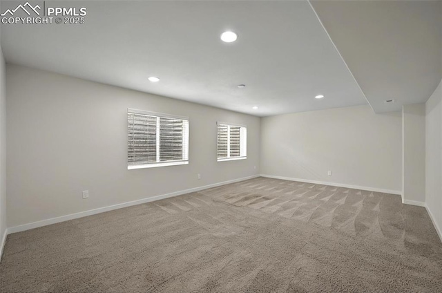 carpeted empty room featuring baseboards and recessed lighting