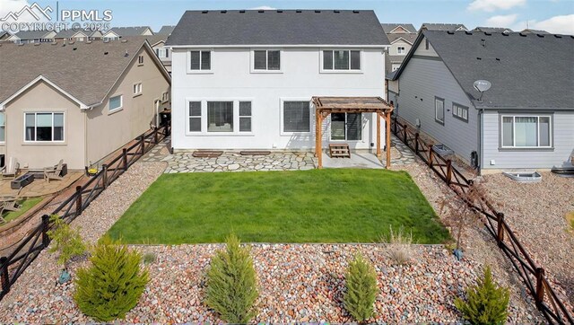 rear view of house with a patio area, a pergola, a residential view, and stucco siding