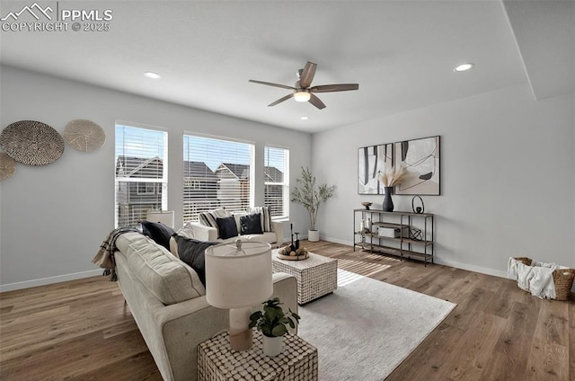 living area with a ceiling fan, wood finished floors, baseboards, and recessed lighting