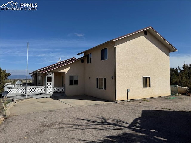 110 Yucca Ave, Florence, CO 81226 - view of side of home featuring stucco siding and a patio