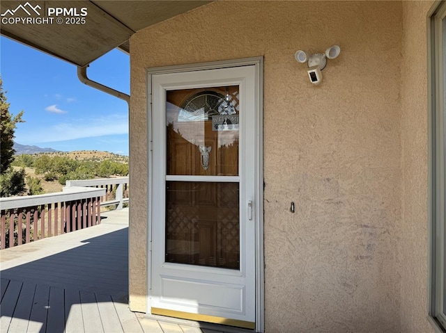 110 Yucca Ave, Florence, CO 81226 - doorway to property with stucco siding and a mountain view