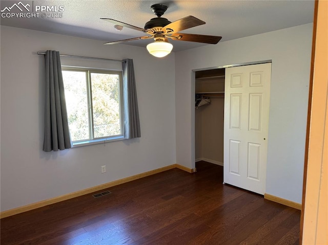 110 Yucca Ave, Florence, CO 81226 - unfurnished bedroom featuring dark wood-style floors, baseboards, a closet, and a ceiling fan