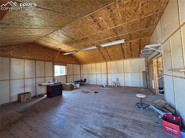 110 Yucca Ave, Florence, CO 81226 - misc room with hardwood / wood-style flooring, lofted ceiling, and a garage