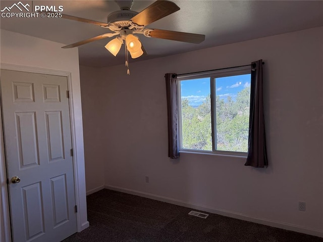 110 Yucca Ave, Florence, CO 81226 - unfurnished bedroom featuring dark carpet, baseboards, and a ceiling fan
