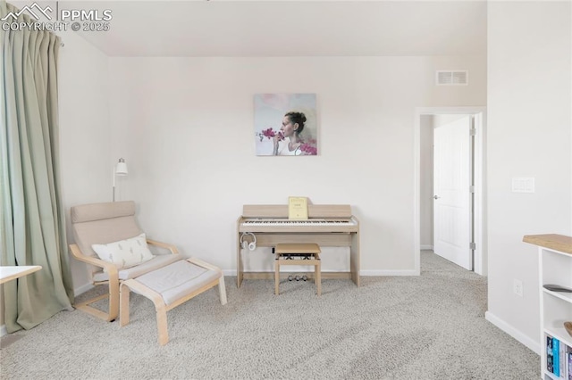 living area featuring carpet and baseboards