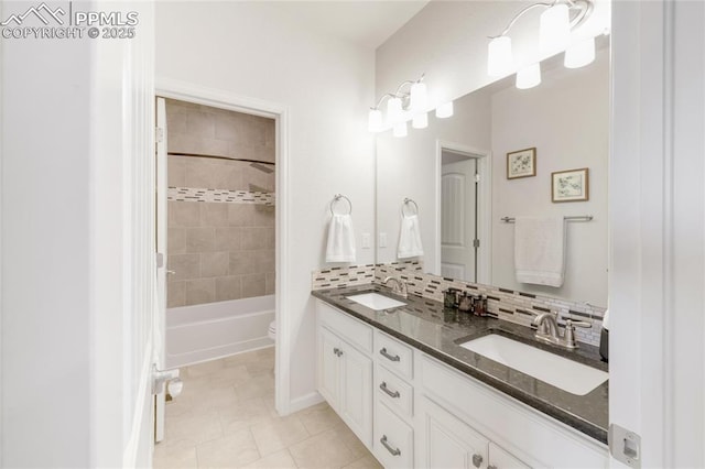 full bathroom with double vanity, tile patterned flooring, toilet, and tasteful backsplash