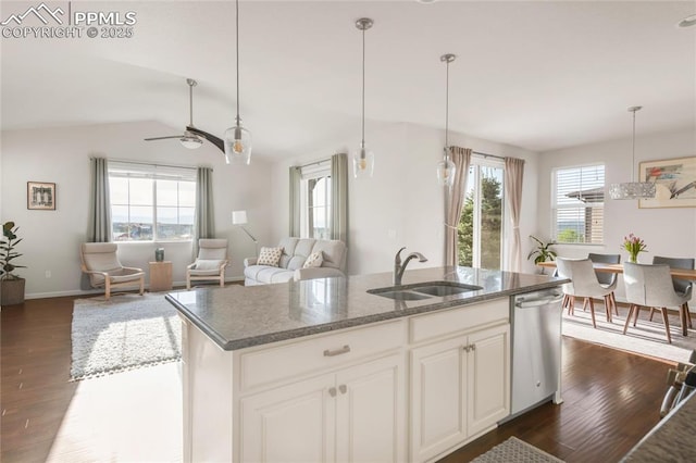 kitchen with a sink, dishwasher, dark wood finished floors, ceiling fan, and vaulted ceiling