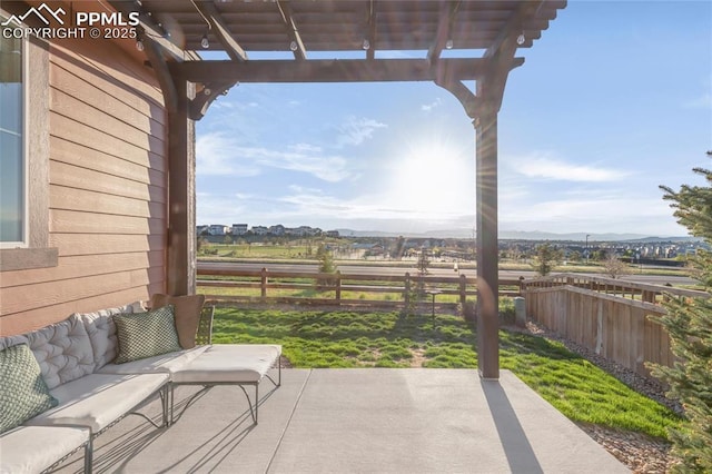 view of patio / terrace with a fenced backyard, a pergola, a mountain view, and a view of rural / pastoral area