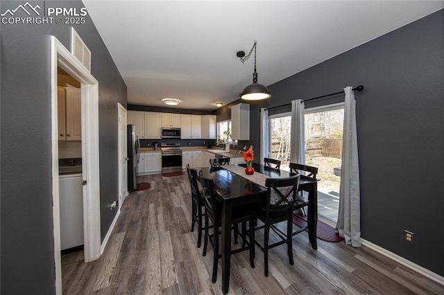 7511 Coffee Rd, Peyton, CO 80831 - dining space with dark wood-type flooring and baseboards