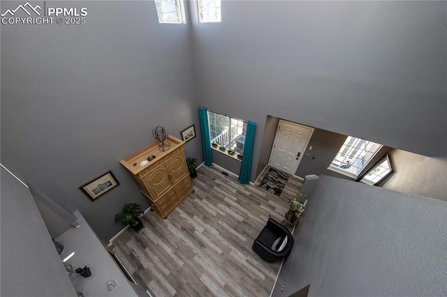 7511 Coffee Rd, Peyton, CO 80831 - entryway with healthy amount of natural light, a high ceiling, and wood finished floors