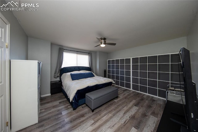 7511 Coffee Rd, Peyton, CO 80831 - bedroom with wood finished floors, ceiling fan, and baseboards