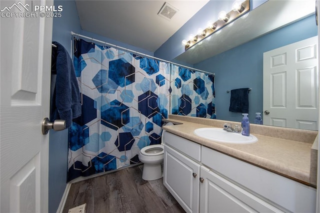 7511 Coffee Rd, Peyton, CO 80831 - bathroom with vanity, wood finished floors, toilet, and a shower with curtain