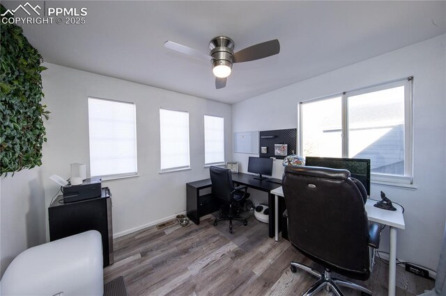 7511 Coffee Rd, Peyton, CO 80831 - office area with ceiling fan, wood finished floors, healthy amount of natural light, and baseboards