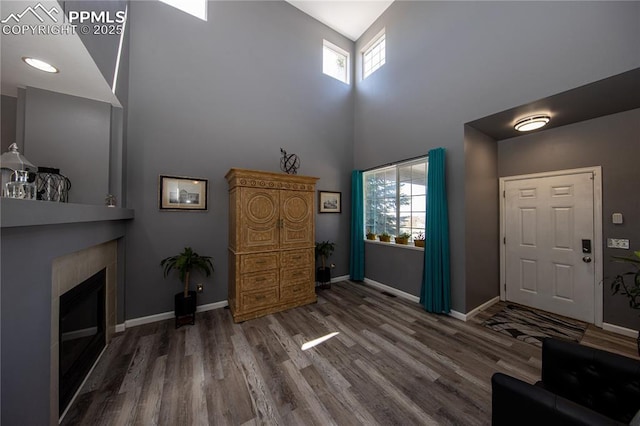 7511 Coffee Rd, Peyton, CO 80831 - foyer featuring a high ceiling, wood finished floors, healthy amount of natural light, and baseboards