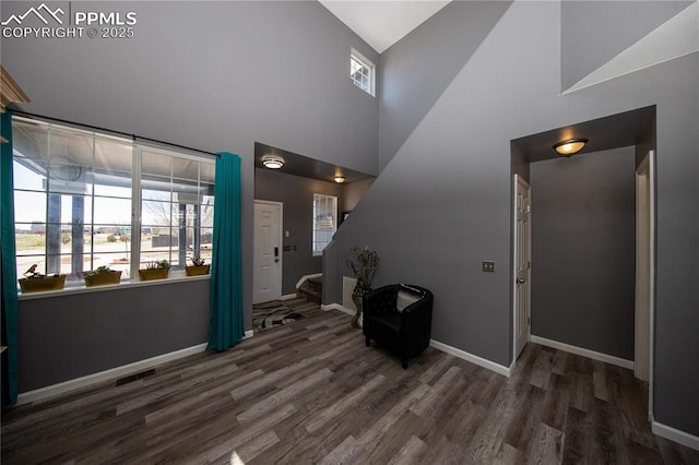 7511 Coffee Rd, Peyton, CO 80831 - foyer with wood finished floors, healthy amount of natural light, high vaulted ceiling, and baseboards