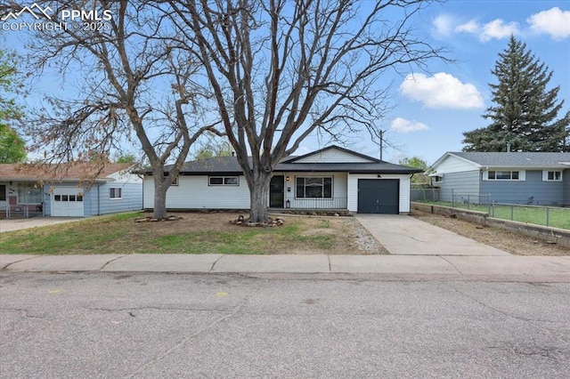 308 Steven Dr, Colorado Springs, CO 80911 - ranch-style home with a garage, fence, and driveway