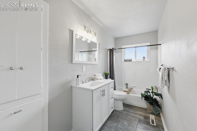 308 Steven Dr, Colorado Springs, CO 80911 - full bath with wood finished floors, vanity, shower / tub combo, toilet, and a textured wall