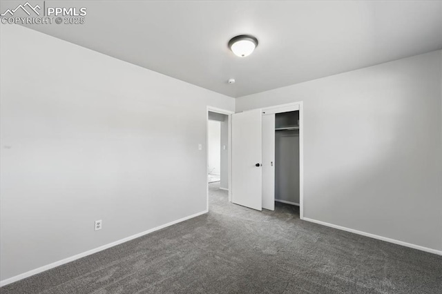308 Steven Dr, Colorado Springs, CO 80911 - unfurnished bedroom with dark carpet, baseboards, and a closet