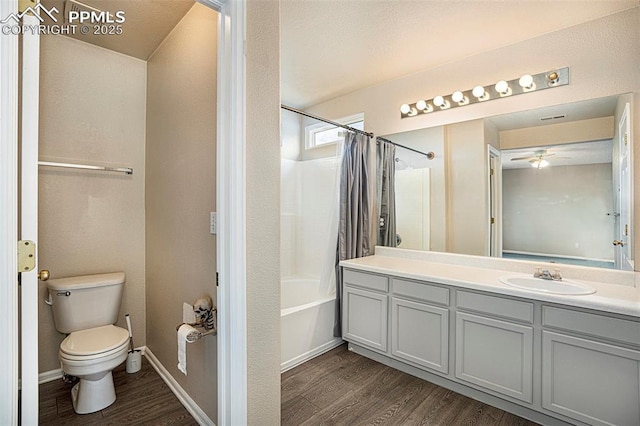 7120 Bonnie Brae Ln, Colorado Springs, CO 80922 - bathroom featuring wood finished floors, a ceiling fan, toilet, shower / bathtub combination with curtain, and vanity