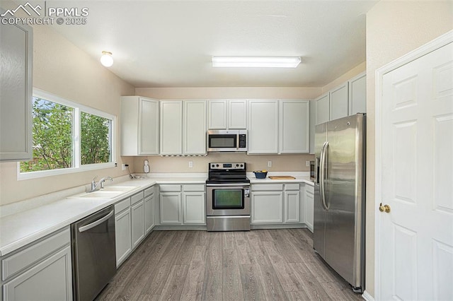 7120 Bonnie Brae Ln, Colorado Springs, CO 80922 - kitchen featuring stainless steel appliances, a sink, light wood-style floors, and light countertops
