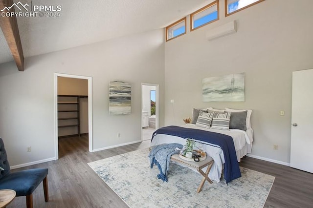 2530 White Rock Ln, Colorado Springs, CO 80904 - bedroom featuring wood finished floors, a spacious closet, baseboards, a high ceiling, and beam ceiling