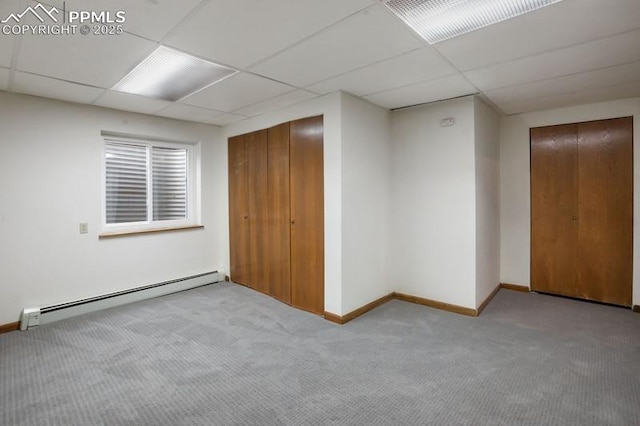 2530 White Rock Ln, Colorado Springs, CO 80904 - unfurnished bedroom with a baseboard heating unit, carpet floors, a paneled ceiling, baseboards, and a closet