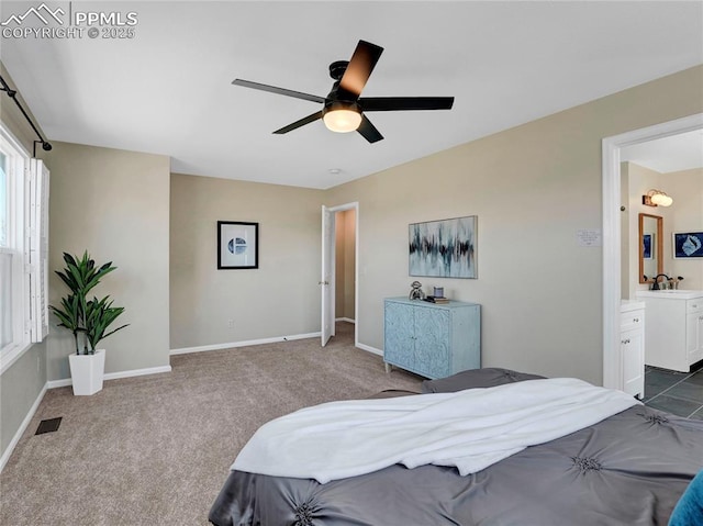 2209 Gilpin Ave, Colorado Springs, CO 80910 - bedroom with dark colored carpet, baseboards, a ceiling fan, connected bathroom, and a sink