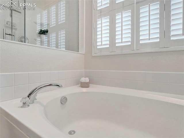2209 Gilpin Ave, Colorado Springs, CO 80910 - full bathroom with a garden tub and a textured wall