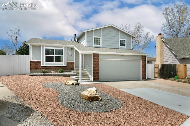 8230 Contrails Dr, Colorado Springs, CO 80920 - tri-level home with brick siding, driveway, and fence