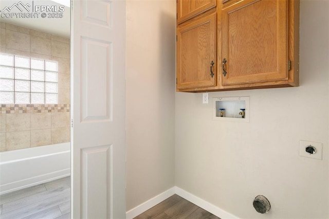 8230 Contrails Dr, Colorado Springs, CO 80920 - laundry area featuring cabinet space, hookup for a washing machine, hookup for an electric dryer, dark wood finished floors, and baseboards