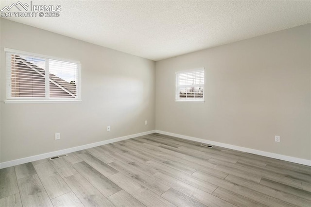 8230 Contrails Dr, Colorado Springs, CO 80920 - unfurnished room with light wood-type flooring, baseboards, and a textured ceiling