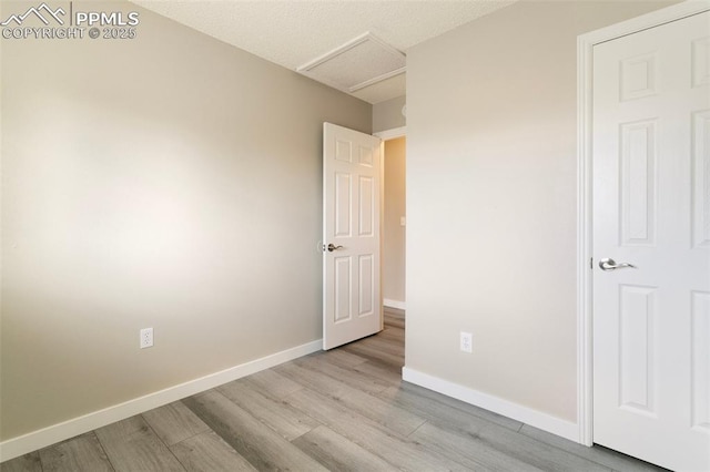 8230 Contrails Dr, Colorado Springs, CO 80920 - unfurnished bedroom featuring attic access, wood finished floors, and baseboards