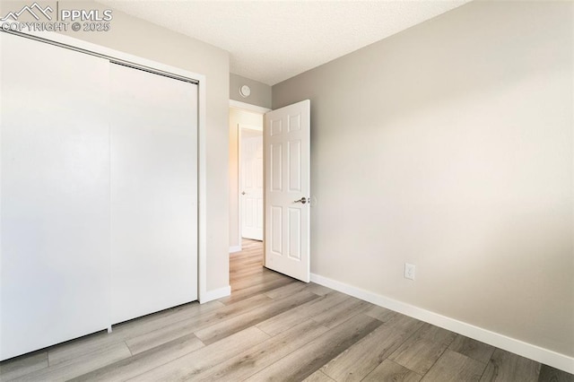 8230 Contrails Dr, Colorado Springs, CO 80920 - unfurnished bedroom featuring wood finished floors, baseboards, and a closet