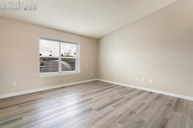 8230 Contrails Dr, Colorado Springs, CO 80920 - empty room featuring wood finished floors, a textured ceiling, and baseboards